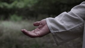 Closeup of Jesus Christ taking the hand of someone to help them - Powered by Shutterstock - Get 15% off with code: PIKWIZARD15