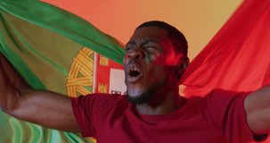 Animation of african american male supporter with flag of portugal over confetti. Global sport and digital interface concept digitally generated video.