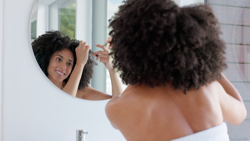 Hair care, beauty and woman in bathroom getting ready for the day at her home. Self care, wellness and girl from Puerto Rico with beautiful, healthy and natural hair with curly hairstyle | Shutterstock HD Video #1096671365