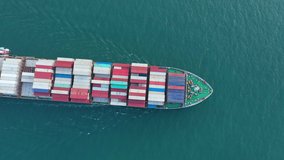 Aerial top view  cargo ship carrying container running directions for export import yard port concept freight shipping by cargo ship.