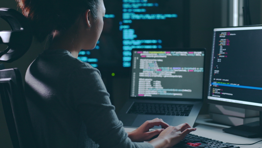Young Asian woman, developer programmer, software engineer, IT support, working hard at night overtime on computer to check coding in bugging system Royalty-Free Stock Footage #1096679239