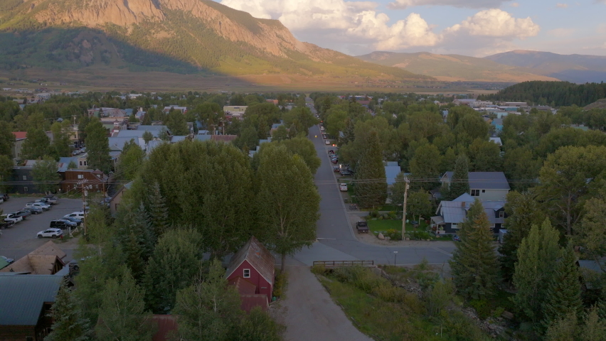 Aerial of Crested Butte with trucking left over neighborhood houses, streets and buildings.
