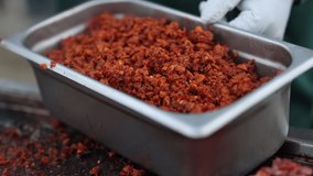 Close-up shot of preparing red meat outdoors. Chef's collecting fried ingredients for traditional Mexican tacos serving. High quality 4k footage