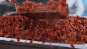 Chef's collecting fried ingredients for traditional Mexican tacos serving. Steamed, hot red meat for street food delicious cuisine. High quality 4k footage