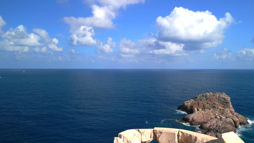 big sky, clouds, stonetop of the old lighthouse. Beautiful aerial view flight