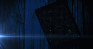 Animation of blue circular scanner and processing data on screen of tablet on wooden boards. Data, global communication and digital interface concept digitally generated video. - Powered by Shutterstock - Get 15% off with code: PIKWIZARD15