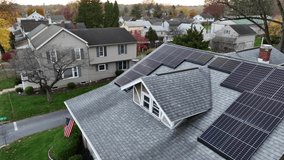 American home with USA flag and green renewable energy theme. Rooftop solar power unit for electricity in America. - Powered by Shutterstock - Get 15% off with code: PIKWIZARD15