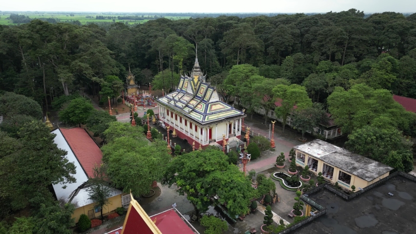Aerial drone footage over Hang Pagoda in Tra Vinh province. Numerous Khmer ancient pagodas can be found in this are. Here camera is moving foward the stunning construction. 1-2