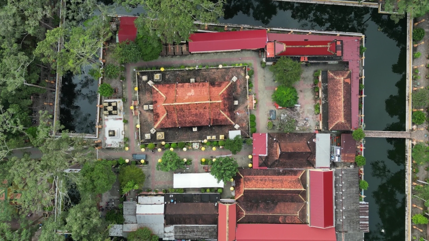 Aerial drone footage over the stunning site of Wat Ang in Tra Vinh city, south Vietnam. Amazing and peaceful environment while the camera looking background and moving backward.