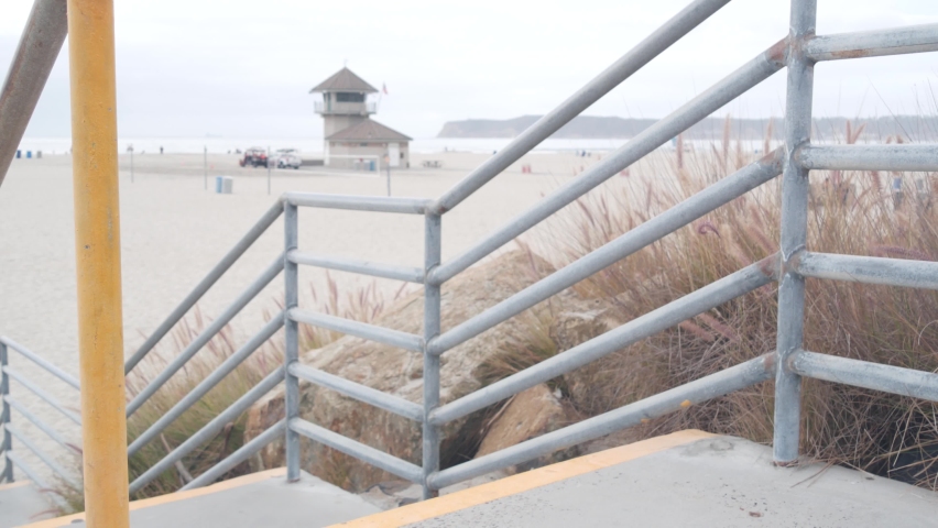 Lifeguard stand or life guard tower hut, surfing safety on California beach, USA. Rescue station, coast lifesavers wachtower or house, Coronado ocean beach, San Diego. Beach access stairs or steps.