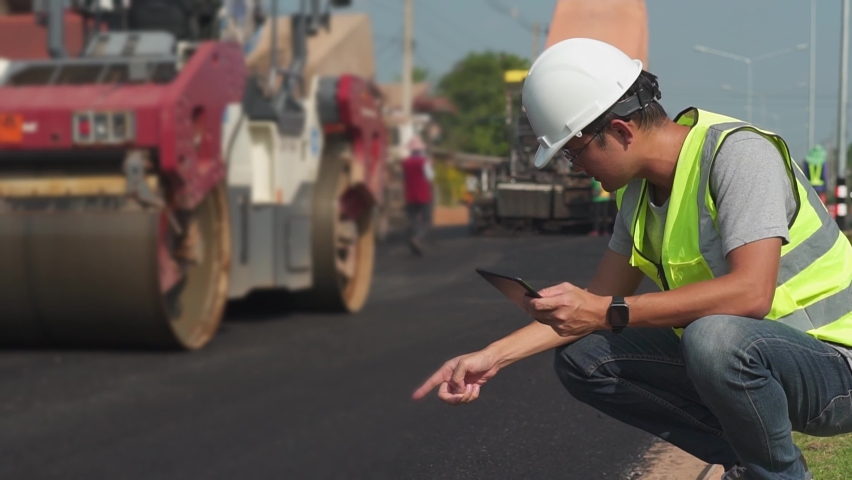 Asian engineers watch road rebuilding and inspect the construction of asphalt the road at the construction site. | Shutterstock HD Video #1096710615