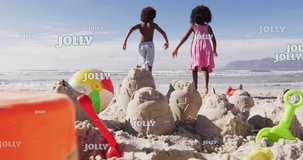 Animation of christmas greetings text over african american children on beach. Christmas, festivity, celebration and tradition concept digitally generated video.