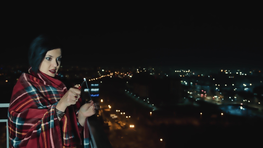 A lonely beautiful woman sets fire to Bengal fireworks. Waiting for a holiday alone