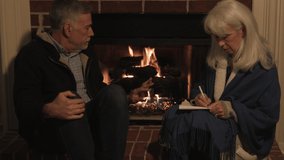 Heating oil supply shortages have this senior adult couple bundled up and huddled by their fireplace working on a plan to heat their home. - Powered by Shutterstock - Get 15% off with code: PIKWIZARD15