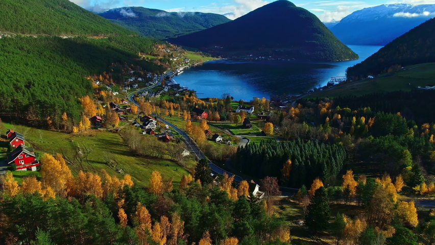 Beautiful aerial flight towards Norwegian fjord surrounded by villages and mountains in autumn season Royalty-Free Stock Footage #1096727967