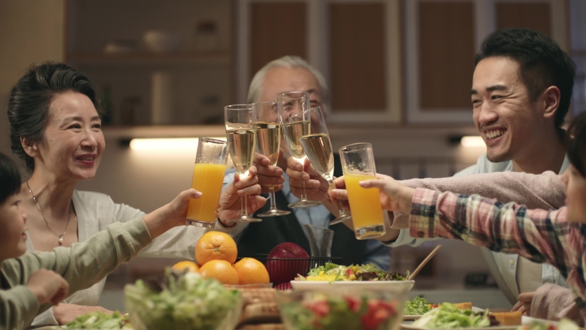 Three generation asian family gathering at home celebrating holiday having a toast | Shutterstock HD Video #1096729841