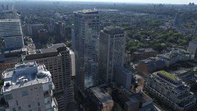 Slow-Pullback Reveal Drone Shot of Yorkville buildings in Toronto, Ontario looking west and north, Mid-Day, Shot on the DJI Inspire 2 and X7 Camera.