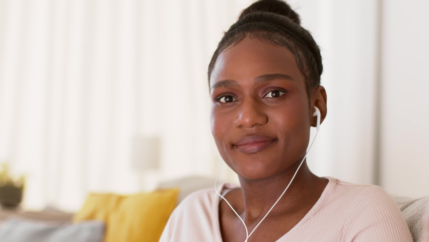 Online meeting. Webcam pov portrait of young positive african american woman in headphones video chatting via internet, waving hand and listening to speaker, slow motion, empty space Royalty-Free Stock Footage #1096735337