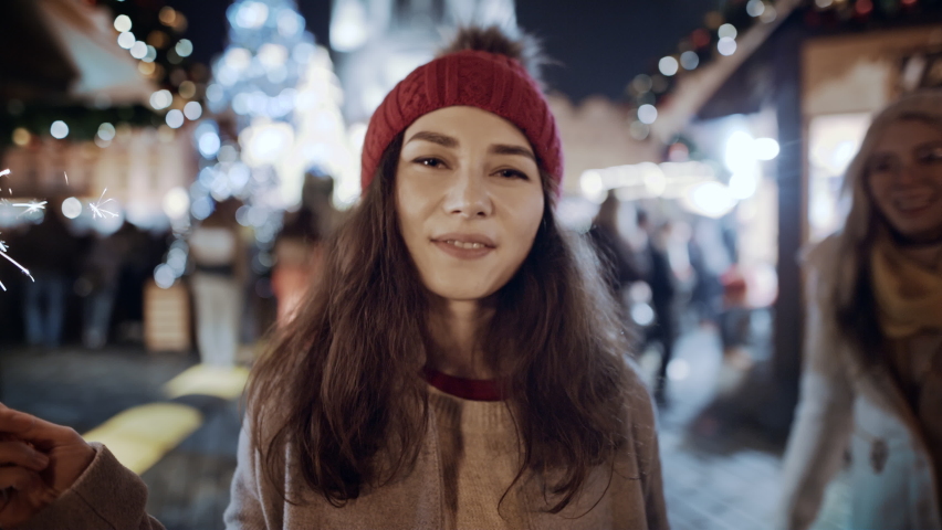 Two female friends meet Christmas  party outdoors Old decorated town square. Happy time together, Asian woman girl making surprise for her mate. Celebrating New Year holidays vacation. Christmas joy Royalty-Free Stock Footage #1096740383