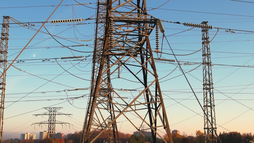 Transmission power tower with wires. Electricity pylon and high voltage power line infrastructure. Electricity transmission from electrical grid for electric car charging or EV vehicle Royalty-Free Stock Footage #1096740991