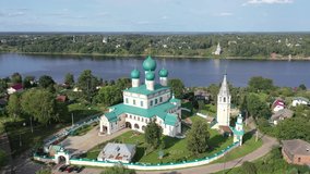 Scenic general aerial view of Russian town of Tutayev divided into two parts by Volga River overlooking Resurrection Cathedral on sunny summer day, Yaroslavl Oblast. High quality 4k footage