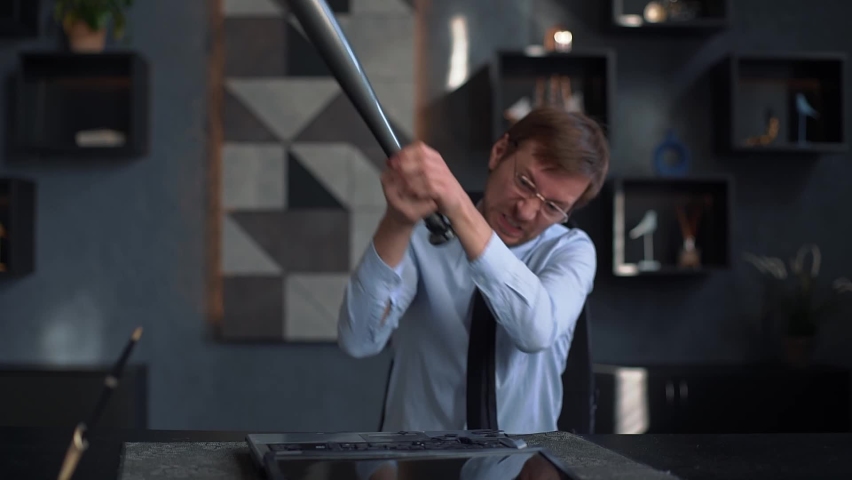 Angry businessman smashes laptop with baseball bat Royalty-Free Stock Footage #1096744963