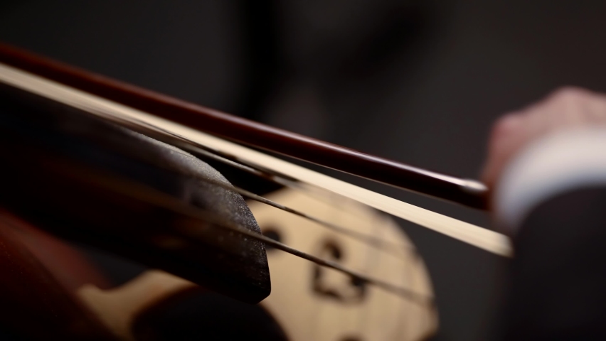 concert of the symphony orchestra close-up of the bow on the cello the concept of the development of musical taste classical music playing stringed classical musical instruments talented people in art Royalty-Free Stock Footage #1096753955