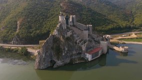 Aerial video of Golubac medieval citadel located on the Danube river on Serbian bank. Footage was shot from a drone at higher altitude with camera level for a panoramic shot around the fortress.