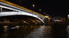 Side view of beautiful illuminated stone bridge in Moscow downtown district above Moskva river at night. Real time video. General architecture theme.