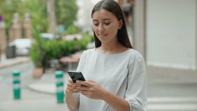 Young beautiful hispanic woman smiling confident having video call at street