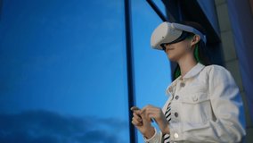 Experience VR. Young woman with virtual reality headset near building, low angle view