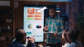 African american executive presenting company financial report, employee speaking in coworking space. Diverse coworkers in business meeting, revenue statistics presentation - Powered by Shutterstock - Get 15% off with code: PIKWIZARD15