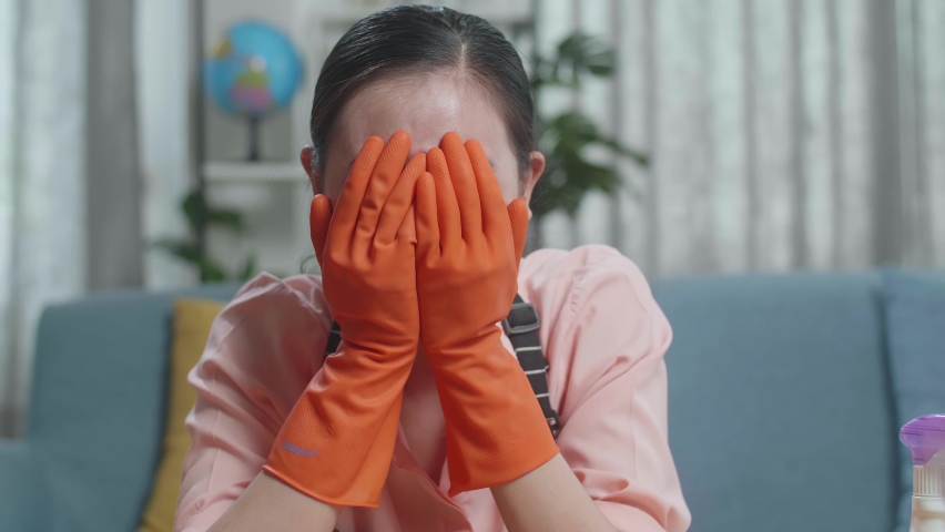 Close Up Of Upset Asian Female Housekeeper With An Apron Crying While Cleaning The Table By The Spray At Home
 | Shutterstock HD Video #1096767519