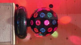 Rotating bright neon disco ball with lights. Multi-colored Disco ball on a stand. Retro style Disco lamp for party. Vintage Spinning Disco Ball with LED Lights - Powered by Shutterstock - Get 15% off with code: PIKWIZARD15