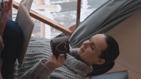 Vertical video. Young woman enjoying scenic natural view of winter nature from geo dome glamping tent, wide shot. Glamping vacation and winter holidays concept - Powered by Shutterstock - Get 15% off with code: PIKWIZARD15