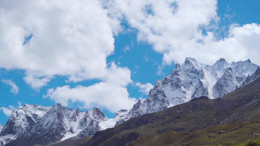 4K shot of clouds above the snow covered Himalayan mountains as seen on the way to Rohtang Pass near Manali in Himachal Pradesh, India. Himalayan Natural background. Clouds move above the mountains.  | Shutterstock HD Video #1096770547