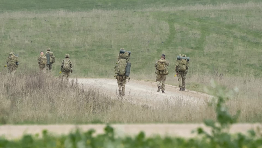 a unit of British army soldiers on a military tab tabbing exercise, Wiltshire UK