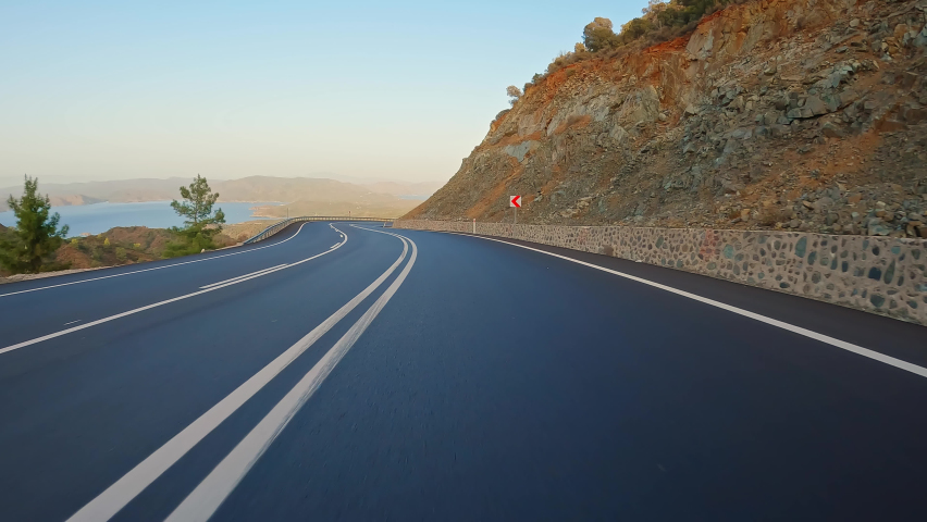 Drive on mountain road with black asphalt and fresh white markings. Travel by car, first-person view. POV transportation drive forward. Royalty-Free Stock Footage #1096781551