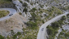 Short drone clip of car driving down a windy road in the mountains of Sa Calobra, Mallorca, Spain.