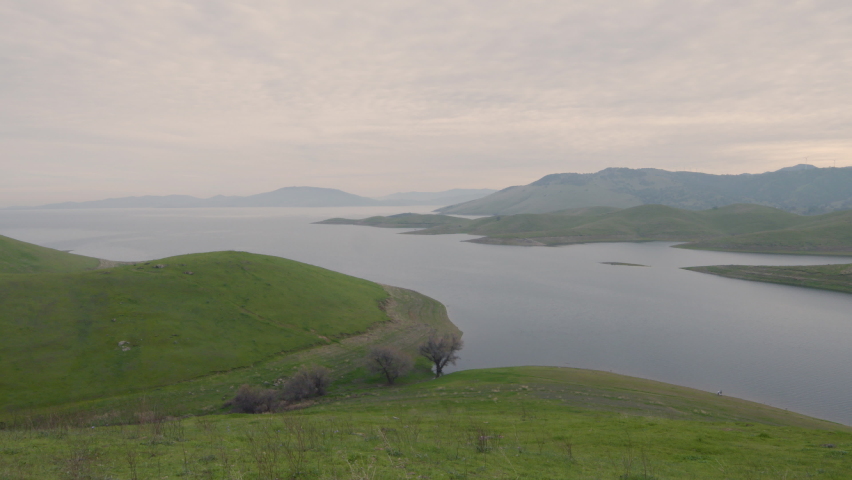 Time lapse of Pacific ocean surrounded by green lush grass located by the Golden Gate National Recreation Area San Francisco California.