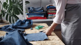 Denim Jeans Recycle and Reuse. Sustainable Fashion. Designer sew from used denim fabric, old jeans. Upcycling process brings new life to old jeans