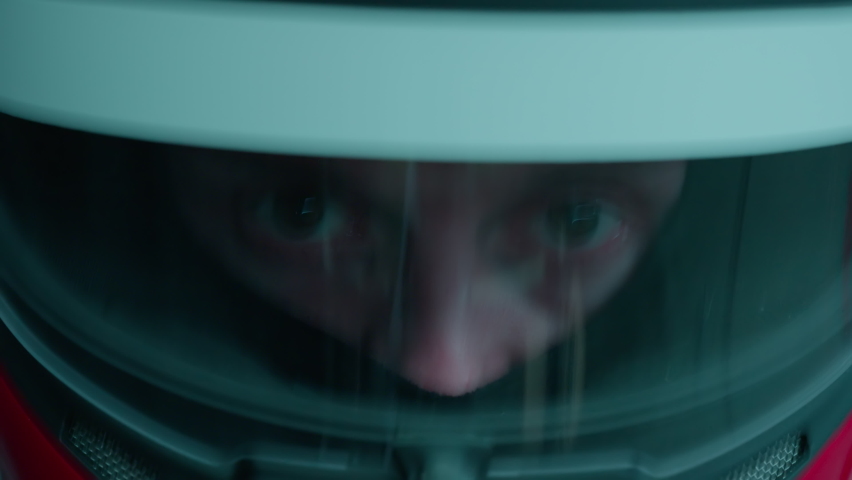 ECU Portrait of sports car driver in protective helmet racing on a speedway. Fast speed, motorsport. Daytime shot Royalty-Free Stock Footage #1096790837