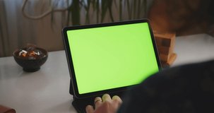Man Typing on a Tablet With Green Screen 