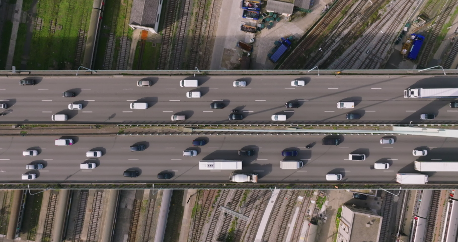 Cars are moving in heavy traffic on the bridge located in the capital of France. Rush hour traffic in the business district of Paris. Drone view of the urban set of cars Royalty-Free Stock Footage #1096796297