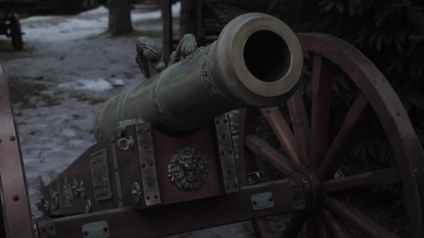 An old medieval cannon in the winter forest