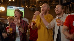 Soccer Club Members Cheering for Their Team, Drinking Beer in a Pub. Supportive Fans Standing in a Bar, Cheering, Raising Glasses and Shouting. Friends Celebrate Victory After the Goal. - Powered by Shutterstock - Get 15% off with code: PIKWIZARD15