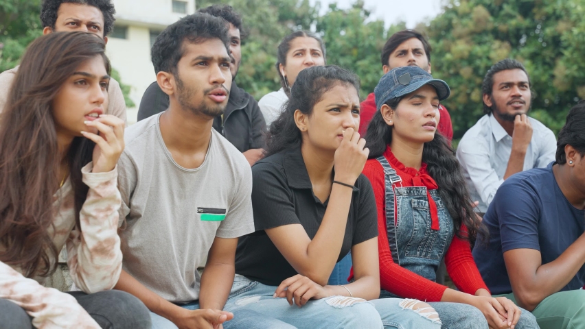 audience in tension seriously watching cricket sports match at stadium - concept of entertainment, emotion and nervous - Powered by Shutterstock - Get 15% off with code: PIKWIZARD15