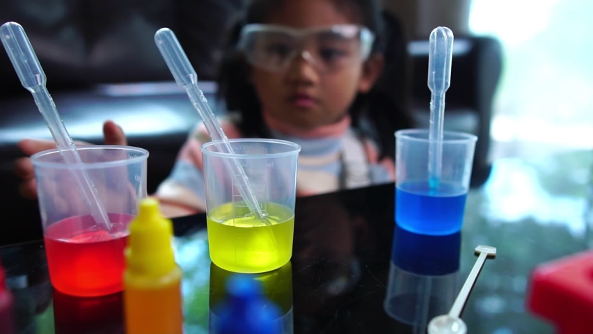 Asian children having fun doing liquid science lab experiments