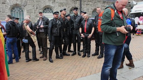 Fetishism - group of men wearing leather clothes posing during gay pride - Victoria Square, Birmingham Gay Pride, England 2015