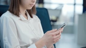 Woman Using Phone Sitting On Sofa In Office Or At Home